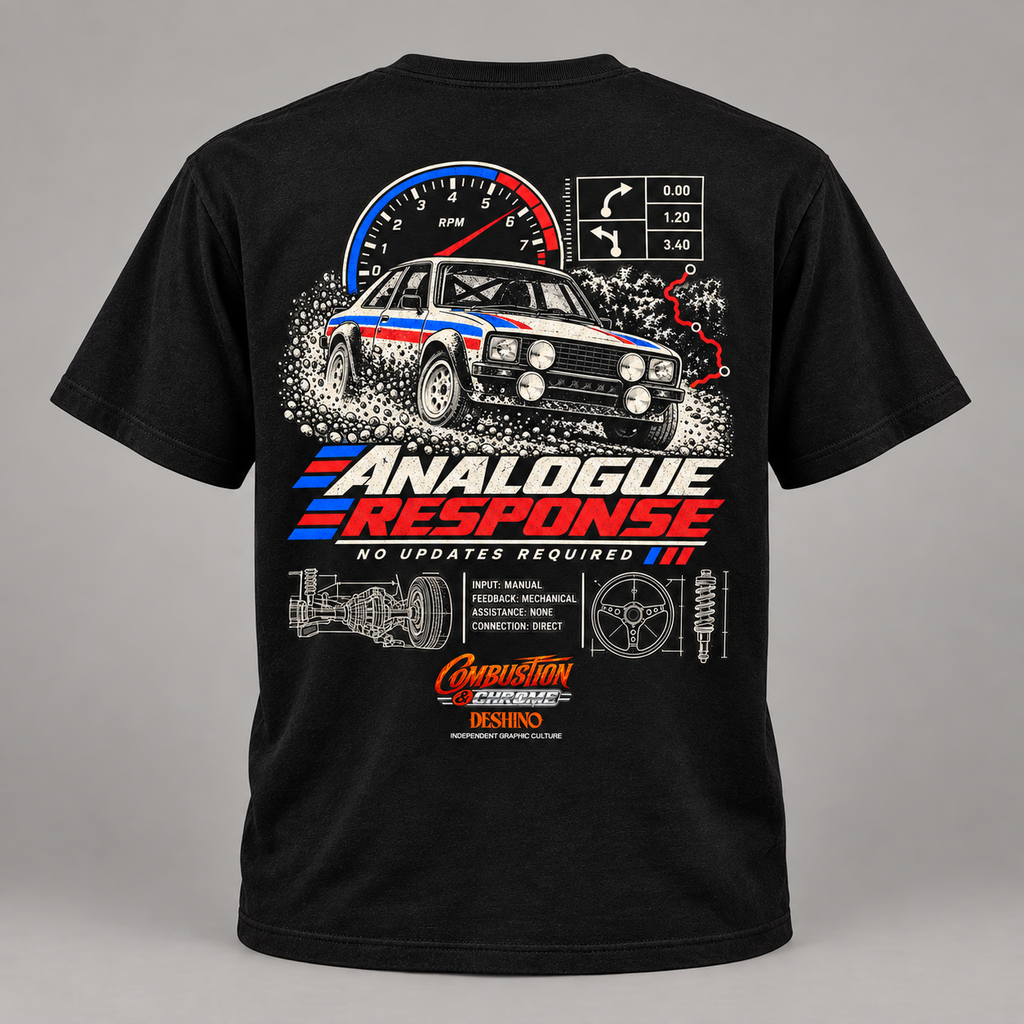 A black short-sleeve t-shirt shown from the back, featuring a large graphic print of a white, red, and blue race car with a speedometer, track map, and the text 'ANALOGUE RESPONSE' and 'NO UPDATES REQUIRED'.