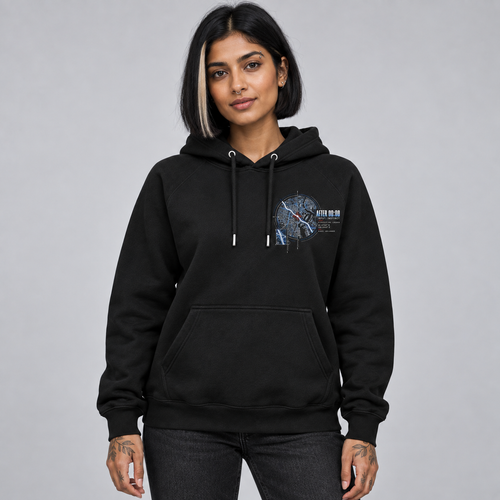 A woman modelling a Deshino black pullover hoodie with a detailed 'After Midnight' graphic print on the left chest, paired with dark grey jeans, against a solid grey studio background.