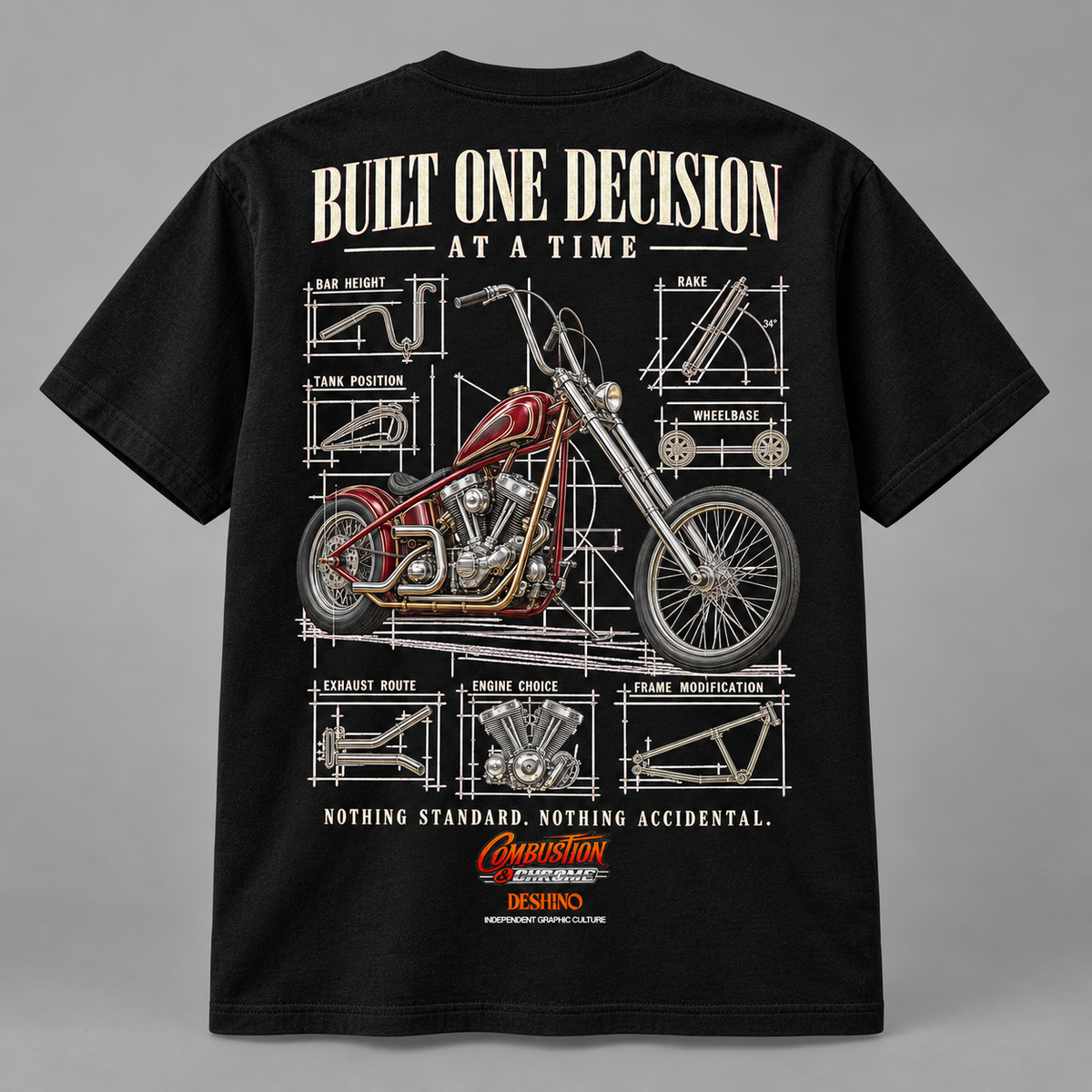 A black short-sleeve graphic T-shirt shown from the back on a neutral gray background. The shirt features a large technical blueprint-style print of a red chopper motorcycle with cream text reading 'BUILT ONE DECISION AT A TIME' and smaller technical callouts.