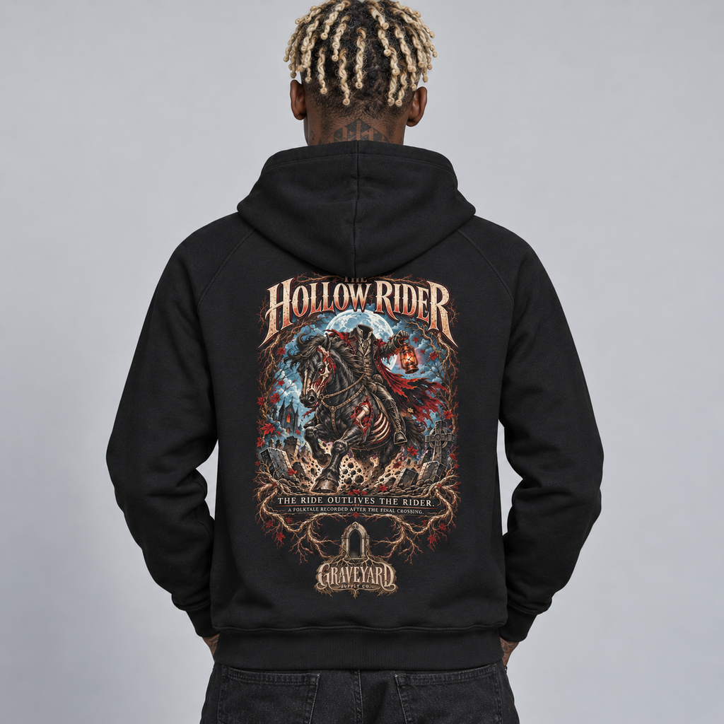 A man viewed from behind wearing a black pullover hoodie with a large, detailed graphic print on the back. The graphic features the text 'HOLLOW RIDER' and 'THE RIDE OUTLIVES THE RIDER' with a dark fantasy illustration of a headless rider on a horse, and a 'Graveyard' logo at the bottom. 