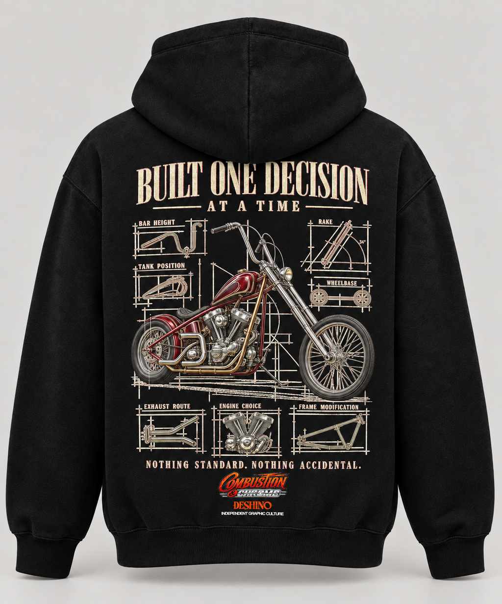 Black pullover hoodie shown from the back, featuring a large motorcycle blueprint-style graphic with the text 'BUILT ONE DECISION AT A TIME' and smaller technical drawing elements. The hoodie is photographed on a light gray studio background.