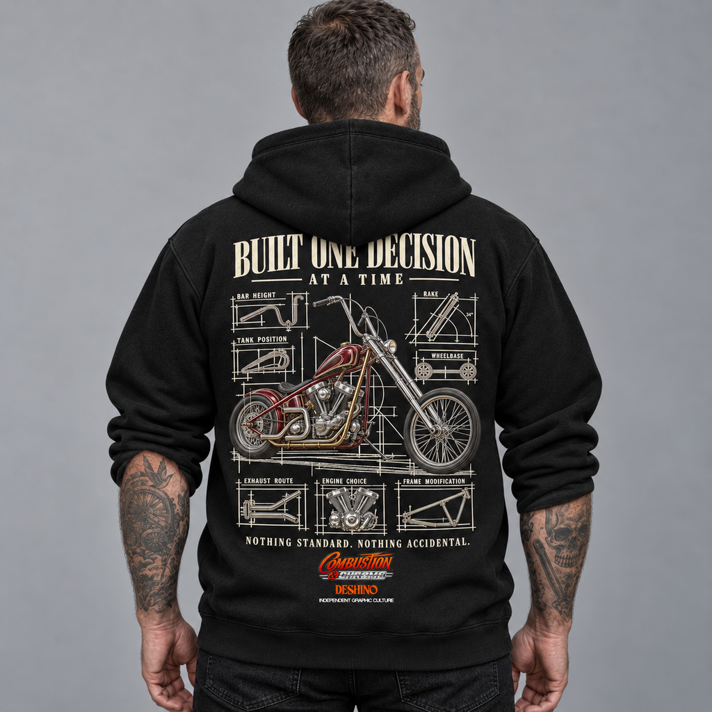 A man viewed from behind wearing a black hoodie with a large motorcycle blueprint graphic on the back. The graphic features a red chopper motorcycle and technical-style diagrams with text including 'BUILT ONE DECISION AT A TIME'.