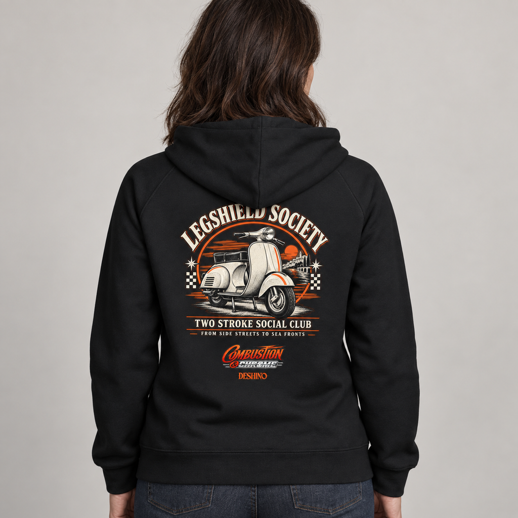 A person shown from the back wearing a black hoodie with a large vintage-style graphic on the back. The graphic features a white scooter, orange and cream text reading 'Legshield Society' and 'Two Stroke Social Club,' plus smaller red and orange branding near the bottom.