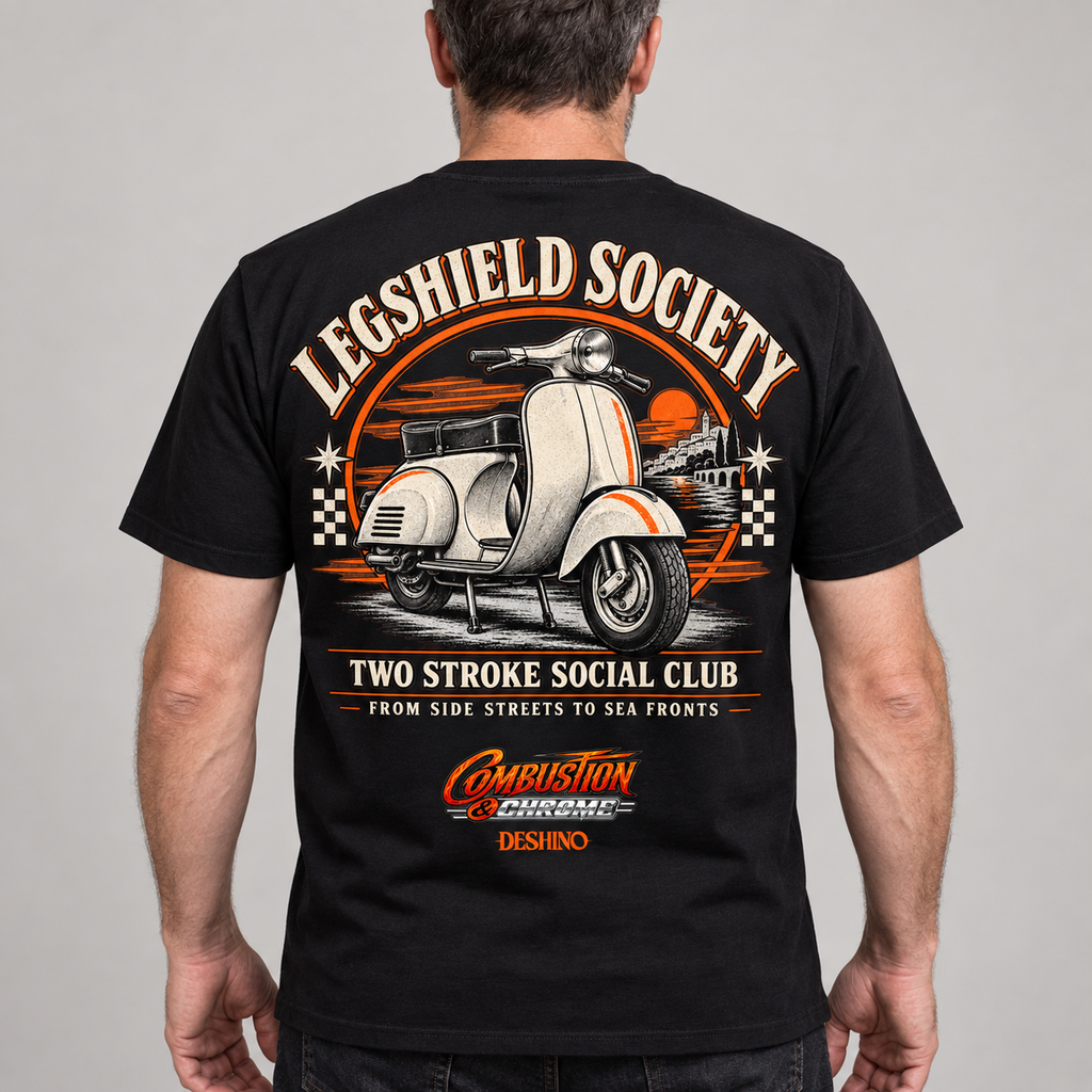 A man viewed from the back wearing a black t-shirt with a large vintage-style graphic on the back. The graphic features a white scooter, orange and beige text reading 'LEGSHIELD SOCIETY' and 'TWO STROKE SOCIAL CLUB', and a 'Combustion & Chrome' logo near the bottom.