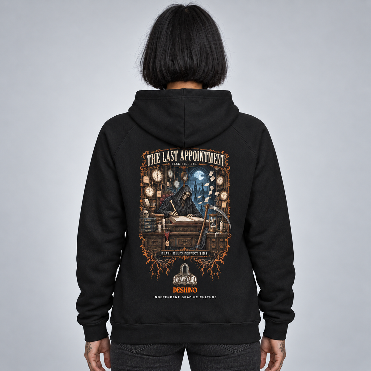 A person shown from the back wearing a black hoodie with a large detailed graphic print on the back. The graphic features a grim reaper, a clockwork mechanism, and the text 'THE LAST APPOINTMENT'.