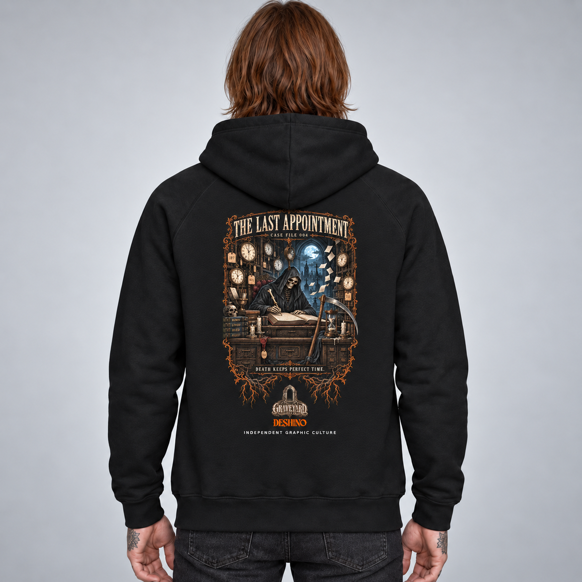 A person shown from the back wearing a black hoodie with a large detailed graphic print on the back. The graphic features a dark gothic illustration with the text 'THE LAST APPOINTMENT'.