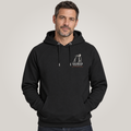 A man wearing a black pullover hoodie with a white 'Legshield Society' logo on the left chest, set against a plain light gray studio background.