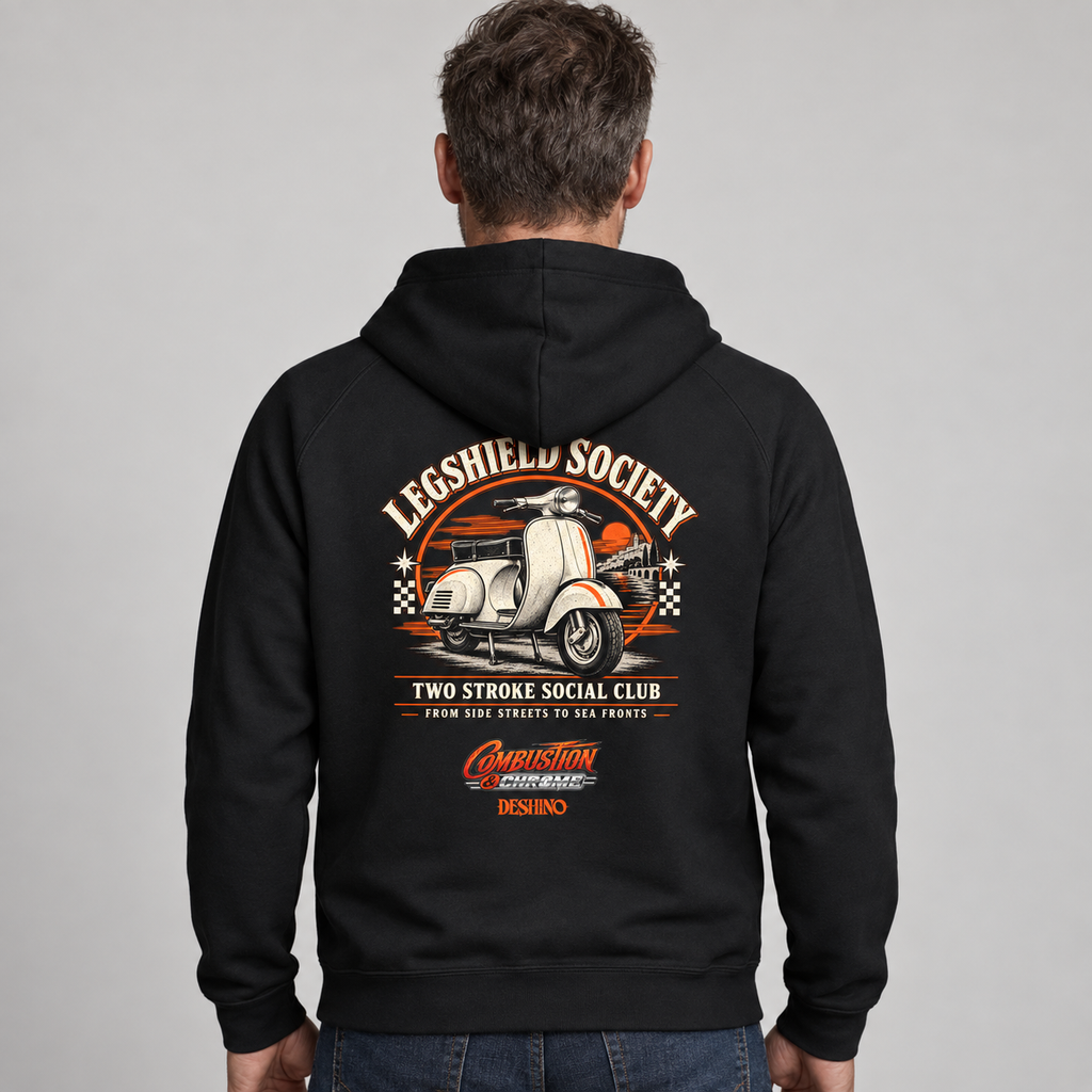 A man viewed from the back wearing a black hoodie with a large vintage-style graphic on the back. The design features a white scooter, orange and beige text reading 'Legshield Society' and 'Two Stroke Social Club,' plus smaller decorative text and logos near the lower back.