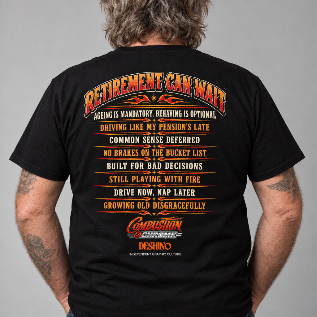 A man viewed from the back wearing a black t-shirt with a large orange and yellow graphic text that reads 'RETIREMENT CAN WAIT' and a list of humorous retirement-related statements. The 'Combustion & Chrome & Deshino' logo is visible at the bottom of the graphic.