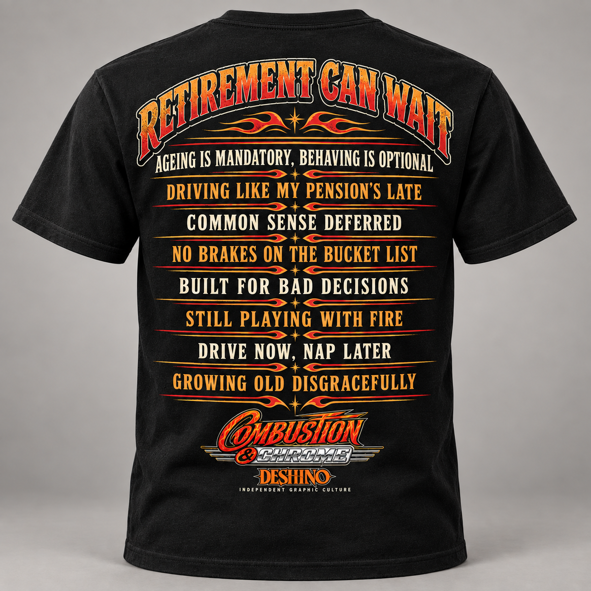 A black short-sleeve t-shirt shown from the back, featuring a large red, orange, and yellow graphic text print that reads 'RETIREMENT CAN WAIT' with humorous retirement-themed statements and the 'Combustion & Chrome' & 'Dehsino'' logo at the bottom.

