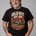 A man wearing a black graphic t-shirt with a vintage hot rod car design and flames. The text on the shirt reads 'OLD GIT HOT ROD' and 'GROWING OLD DISGRACEFULLY' & COMBUSTION & CHROME LOGO'.
