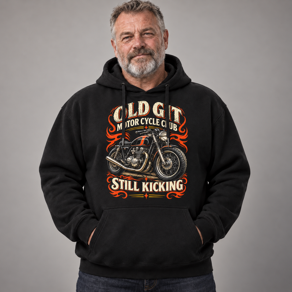 A man wearing a black pullover hoodie with a vintage-style graphic of a motorcycle and the text 'OLD GIT MOTORCYCLE CLUB STILL KICKING' on a plain gray studio background.