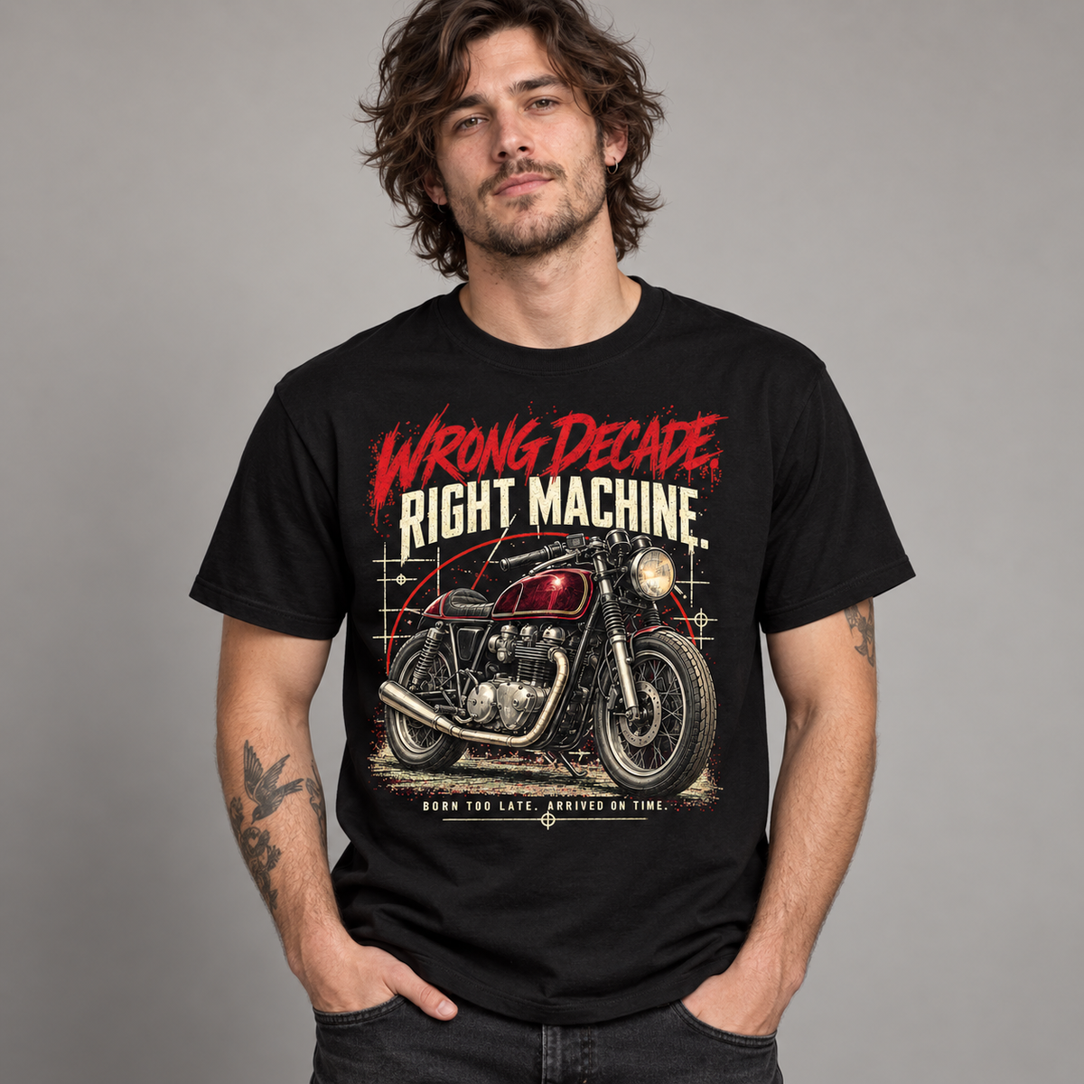A man wearing a black graphic t-shirt with a vintage motorcycle design and the text 'WRONG DECADE RIGHT MACHINE'.