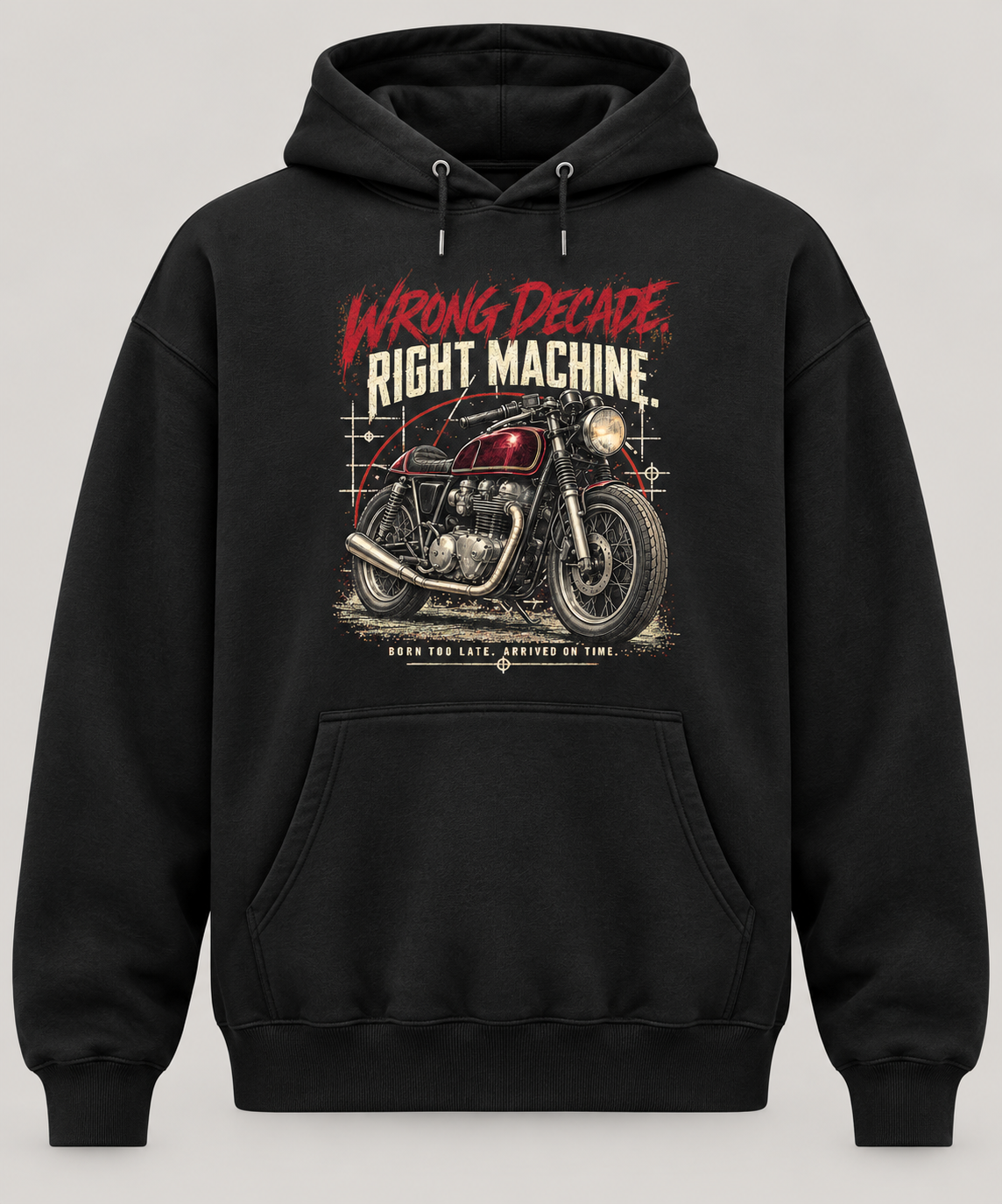 A black pullover hoodie with a graphic print of a vintage motorcycle and the text 'WRONG DECADE RIGHT MACHINE' on the front, shown against a neutral light grey background.